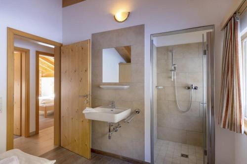 a bathroom with a sink and a shower at Schöneben Haus Anemone in Wald im Pinzgau