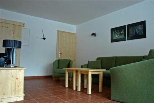 a living room with a couch and a table at Schöneben Haus Wenters in Wald im Pinzgau