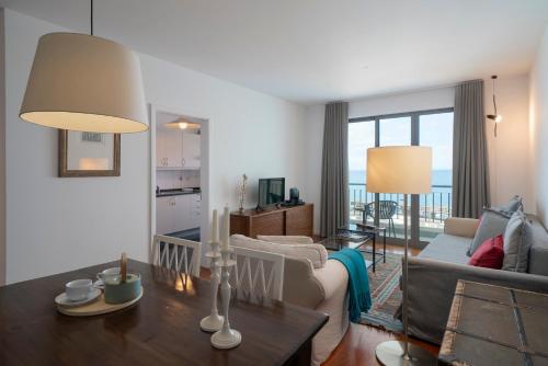 a living room with a couch and a table at Apartamento Princesa Dona Amélia by An Island Apart in Funchal