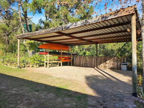 a wooden pergola with a table and chairs under it at Riverview House Sedgefield in Sedgefield