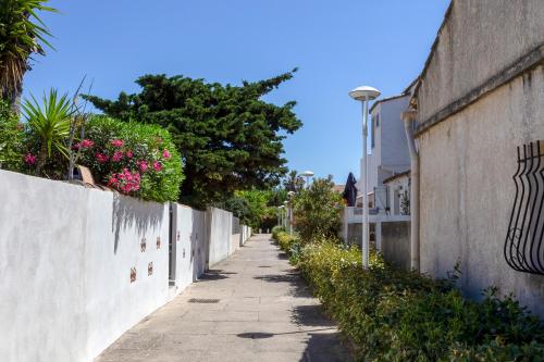 an alley with flowers on the side of a wall at Chez Misha - Sublime maison climatisée à 100m des plages de Carnon in Mauguio