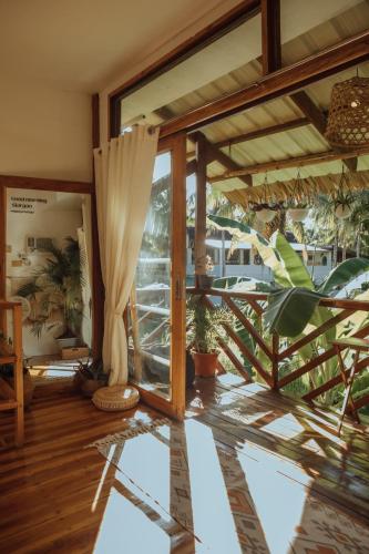 a room with a large glass door and a patio at Mango Tango Villas Siargao in General Luna