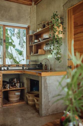 a kitchen with a sink and a counter with baskets at Mango Tango Villas Siargao in General Luna