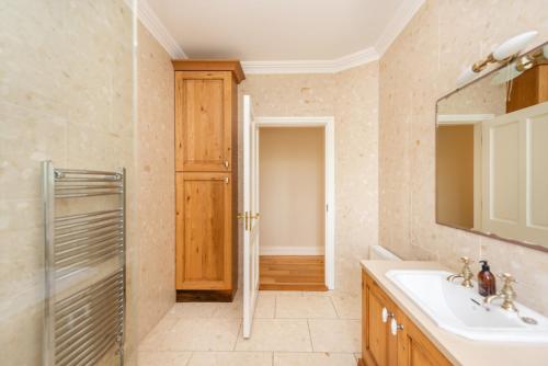 a bathroom with a sink and a mirror at Beautiful 5-Bed Villa in Waterford in Waterford