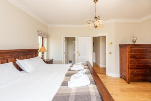 a bedroom with a bed with two towels on it at Beautiful 5-Bed Villa in Waterford in Waterford