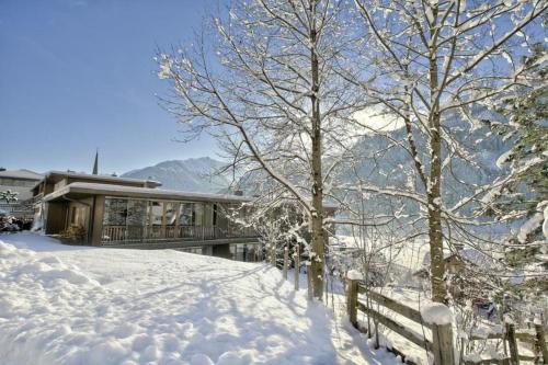 a house in the snow with a fence at Schöneben Haus Edelweiss in Wald im Pinzgau