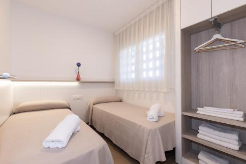 a room with two beds and a window at Rentalmar Murillo Plus in Salou