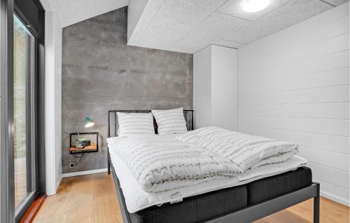 a bedroom with a large bed with white sheets at Gorgeous Home In Sjølund With Kitchen in Sjølund