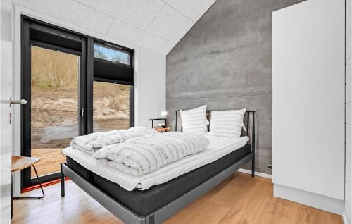 a bedroom with a large bed and a large window at Gorgeous Home In Sjølund With Kitchen in Sjølund