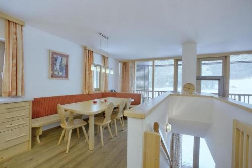 a kitchen and dining room with a table and chairs at Schöneben Haus Sonneck in Wald im Pinzgau