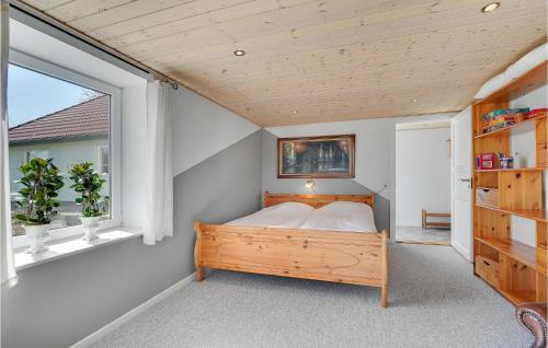 a bedroom with a bed and a window at 3 Bedroom Beautiful Apartment In Kibæk in Kibæk