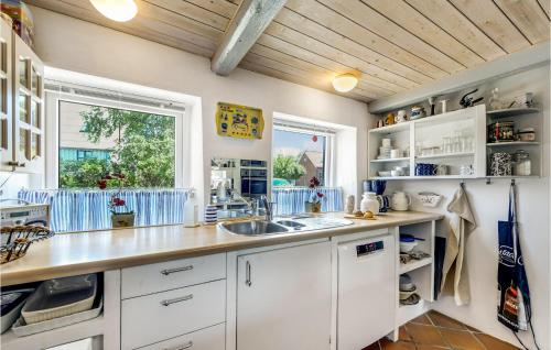 a kitchen with white cabinets and a sink and a window at Two-Bedroom Holiday Home In Haderslev in Haderslev