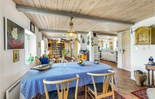 a kitchen and dining room with a table and chairs at Two-Bedroom Holiday Home In Haderslev in Haderslev