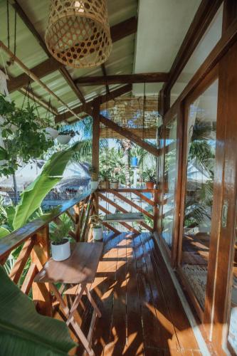 a balcony with a table and some plants at Mango Tango Villas Siargao in General Luna
