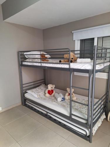a bunk bed with stuffed animals on the bottom shelf at Hermes complex1 paralimni in Paralimni