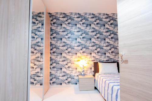 a bedroom with a bed and a wall mural at Mellieha, Charming 2 Bedroom Apartment Santa Maria Heights Mellieha in Mellieħa