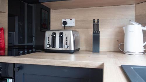 a toaster sitting on top of a kitchen counter at Beauly House in Falkirk