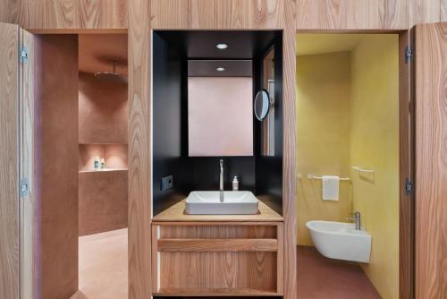 a bathroom with a sink and a mirror at ICARO Hotel in Alpe di Siusi