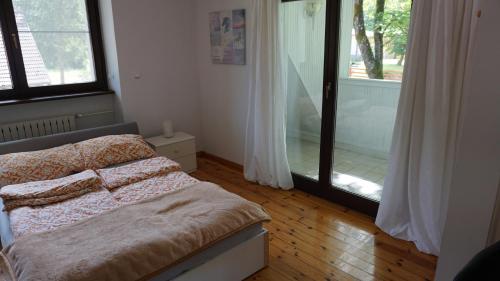 a bedroom with a bed and a sliding glass door at Pensjonat Kowalski in Łubowo