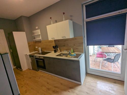 a kitchen with a sink and a stove at Stadtnah an der Förde 27 3 OG R in Flensburg