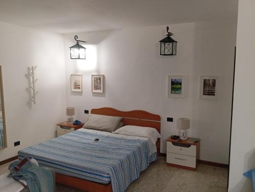 a bedroom with a bed and two night stands and two lamps at Casina di Adele apartment in Volterra