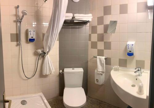 a bathroom with a toilet and a sink at Campanile Grenoble Centre Gare in Grenoble