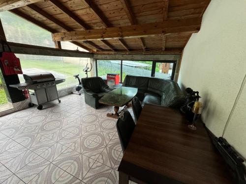 a living room with a couch and a table and a grill at Noclegi Gródek nad Dunajcem in Gródek Nad Dunajcem