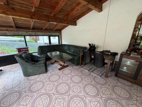 a living room with a couch and a table at Noclegi Gródek nad Dunajcem in Gródek Nad Dunajcem