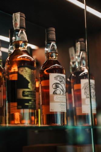 a group of bottles of whiskey on a shelf at Badia Hill in Badia