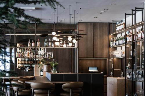 a restaurant with a bar with stools and a laptop at Badia Hill in Badia