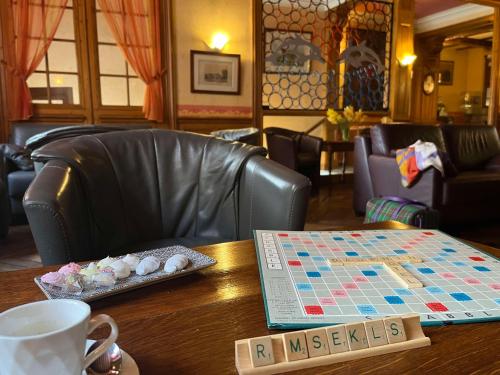 a table with a chess board and a map on it at Brit Hotel Du Dauphin L'Aigle in LʼAigle