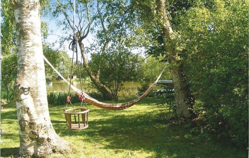 a hammock hanging from a tree in a park at Lindersgården in Staffanstorp