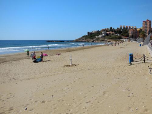 a group of people on a beach with the ocean at Villas Oropesa del Mar 3000 in Oropesa del Mar