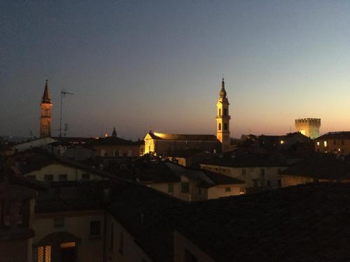 a view of a city at night with two towers at B&B La Fontana in Spilamberto