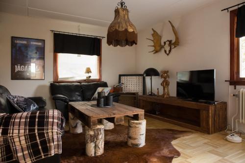 a living room with a couch and a table at Lansån 46 Guesthouse in Krokfors