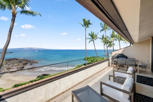 a balcony with a view of the ocean at Makena Surf G303, Maui on the Beach in Wailea