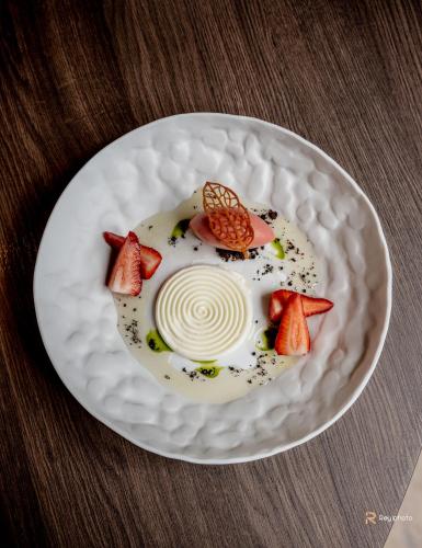 a plate of food with strawberries on a table at Badia Hill in Badia