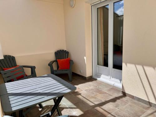 a room with two chairs and a table and a window at BRIT HOTEL Lannion-Perros Guirec in Lannion
