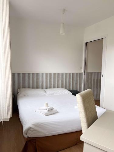 a hotel room with a bed with a towel on it at BRIT HOTEL Lannion-Perros Guirec in Lannion