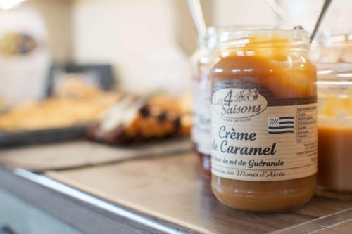 a jar of honey sitting on top of a counter at BRIT HOTEL Lannion-Perros Guirec in Lannion