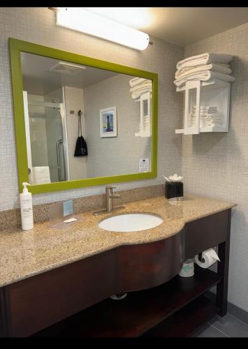 a bathroom with a sink and a large mirror at Hampton Inn New Bedford/Fairhaven in Fairhaven