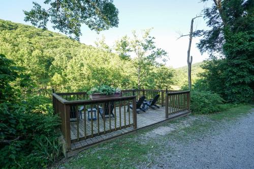 a wooden deck with a person sitting on it at River Front Resort in Elkins