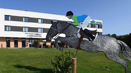 a statue of a person riding a horse at Brit Hotel Ploermel - Hotel de l'Hippodrome in Ploërmel