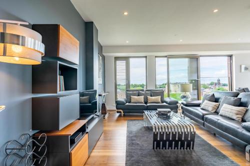 a living room with a couch and a table at Minster View Penthouse at Ryedale House in York