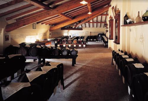 a room with a bunch of wine barrels at B&B La Fontana in Spilamberto