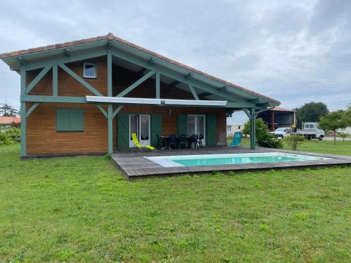 a house with a pool in front of it at Villa landaise à 9km de l'Océan in Saint-Julien-en-Born