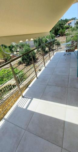 a patio with a fence and a chair on it at Electra Villa & Pool Studios in Gaios