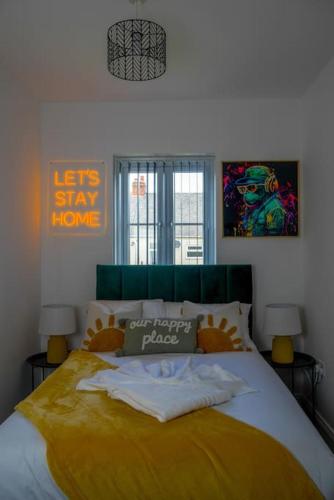 a bedroom with a large bed with a yellow blanket at Free Parking, Families, Short Stays - Durham in Durham