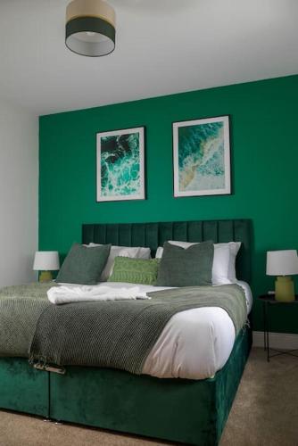 a green bedroom with a bed with a green wall at Free Parking, Families, Short Stays - Durham in Durham