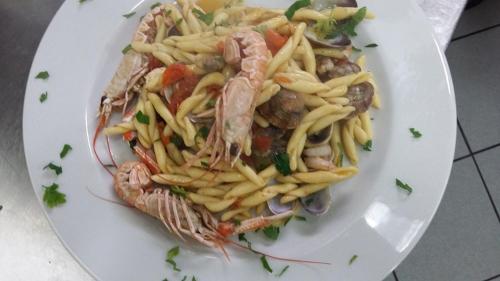 a plate of food with pasta and shrimp at Hotel Ristorante Antica Marina in Nicotera Marina